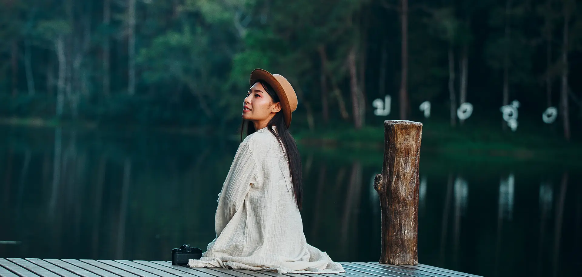lonely-woman-sitting-waterfront-raft
